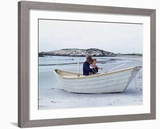 President John Kennedy and John Jr. Play in a Beached Rowboat at Newport, Rhode Island. 1962-null-Framed Photo