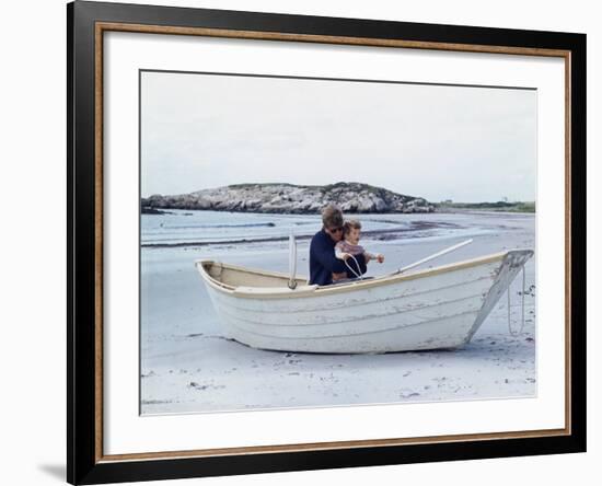 President John Kennedy and John Jr. Play in a Beached Rowboat at Newport, Rhode Island. 1962-null-Framed Photo