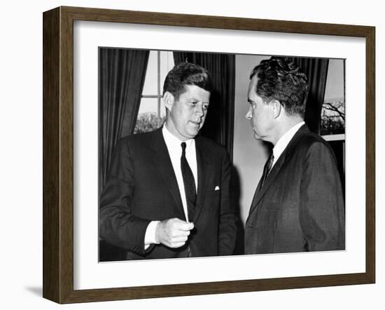 President John Kennedy Confers with Former Vice President Richard Nixon-null-Framed Photo