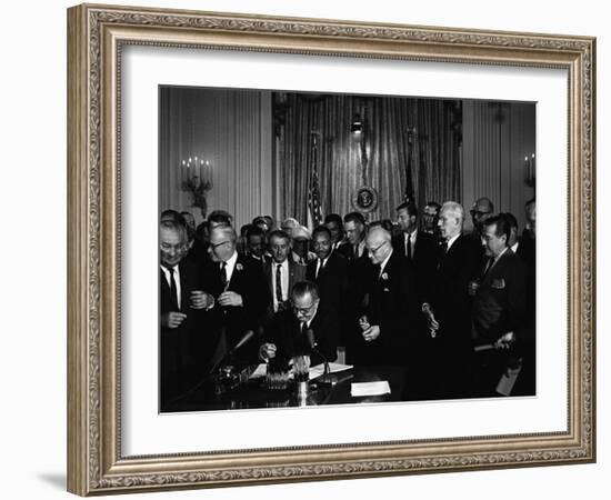 President Lyndon Johnson, Watched by Martin Luther King, Jr. Signing Civil Rights Act, July 2, 1964-null-Framed Photo