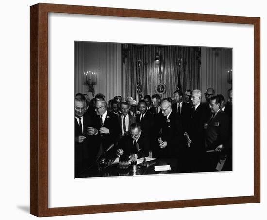 President Lyndon Johnson, Watched by Martin Luther King, Jr. Signing Civil Rights Act, July 2, 1964-null-Framed Photo