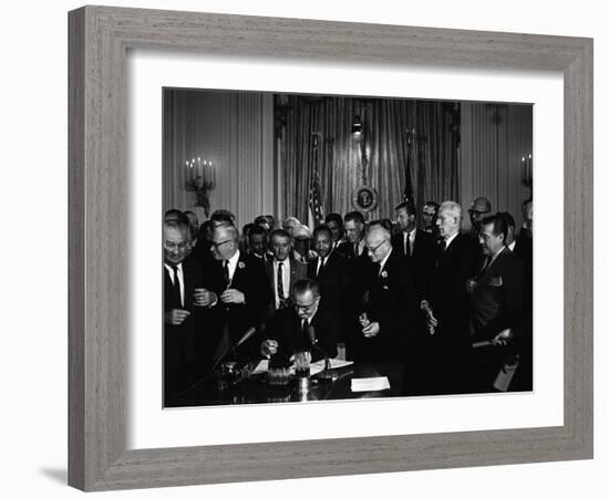 President Lyndon Johnson, Watched by Martin Luther King, Jr. Signing Civil Rights Act, July 2, 1964-null-Framed Photo