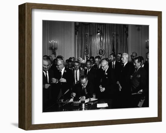 President Lyndon Johnson, Watched by Martin Luther King, Jr. Signing Civil Rights Act, July 2, 1964-null-Framed Photo