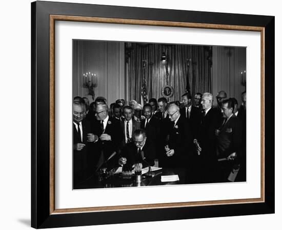 President Lyndon Johnson, Watched by Martin Luther King, Jr. Signing Civil Rights Act, July 2, 1964-null-Framed Photo