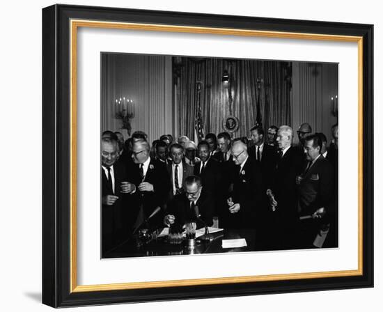 President Lyndon Johnson, Watched by Martin Luther King, Jr. Signing Civil Rights Act, July 2, 1964-null-Framed Photo