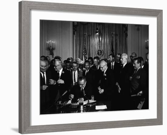 President Lyndon Johnson, Watched by Martin Luther King, Jr. Signing Civil Rights Act, July 2, 1964-null-Framed Photo