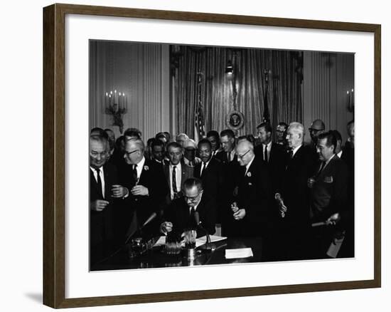 President Lyndon Johnson, Watched by Martin Luther King, Jr. Signing Civil Rights Act, July 2, 1964-null-Framed Photo