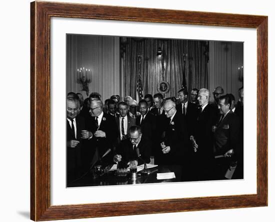 President Lyndon Johnson, Watched by Martin Luther King, Jr. Signing Civil Rights Act, July 2, 1964-null-Framed Photo