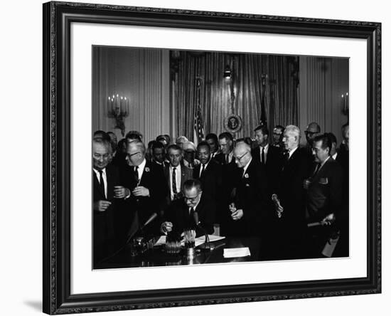 President Lyndon Johnson, Watched by Martin Luther King, Jr. Signing Civil Rights Act, July 2, 1964-null-Framed Photo