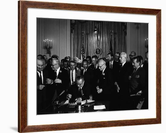 President Lyndon Johnson, Watched by Martin Luther King, Jr. Signing Civil Rights Act, July 2, 1964-null-Framed Photo