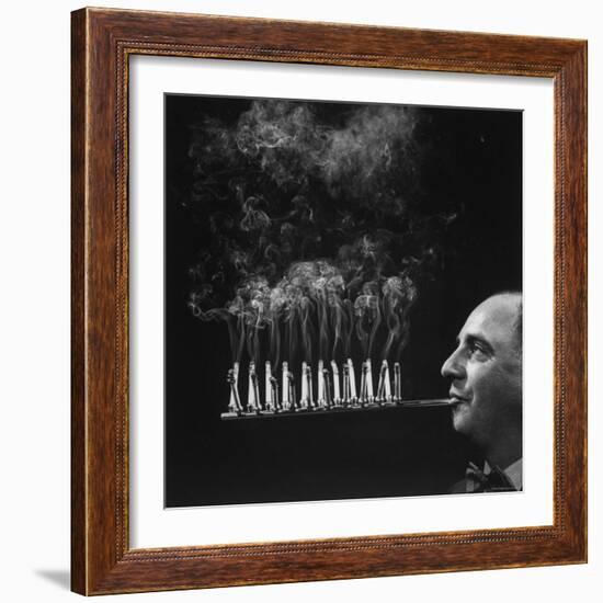 President of Zeus Corp, Robert L. Stern, Smoking Cigarettes from His Self Designed Cigarette Holder-Yale Joel-Framed Photographic Print