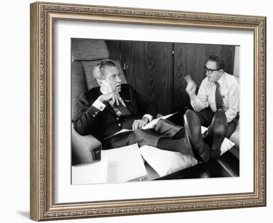 President Richard Nixon and Henry Kissinger Talking on Air Force One-null-Framed Photo