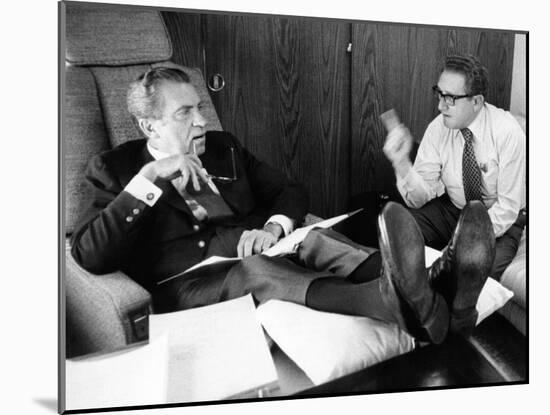 President Richard Nixon and Henry Kissinger Talking on Air Force One-null-Mounted Photo