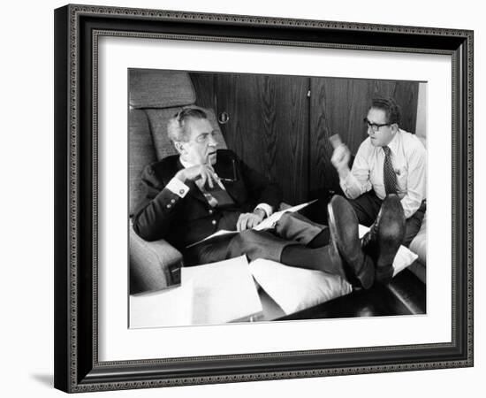 President Richard Nixon and Henry Kissinger Talking on Air Force One-null-Framed Photo