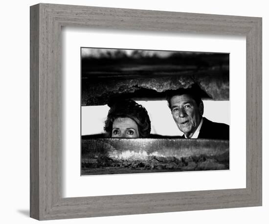 President Ronald Reagan and First Lady Nancy Reagan Peer out of a World War II Bunker-null-Framed Photographic Print