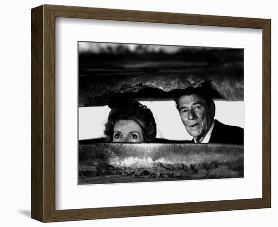 President Ronald Reagan and First Lady Nancy Reagan Peer out of a World War II Bunker-null-Framed Photographic Print