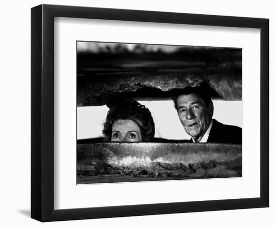 President Ronald Reagan and First Lady Nancy Reagan Peer out of a World War II Bunker-null-Framed Photographic Print