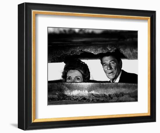 President Ronald Reagan and First Lady Nancy Reagan Peer out of a World War II Bunker-null-Framed Photographic Print