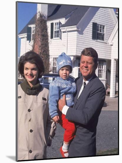 Presidential Candidate John F. Kennedy Holding Daughter with Wife Outside Home on Election Day-Paul Schutzer-Mounted Photographic Print