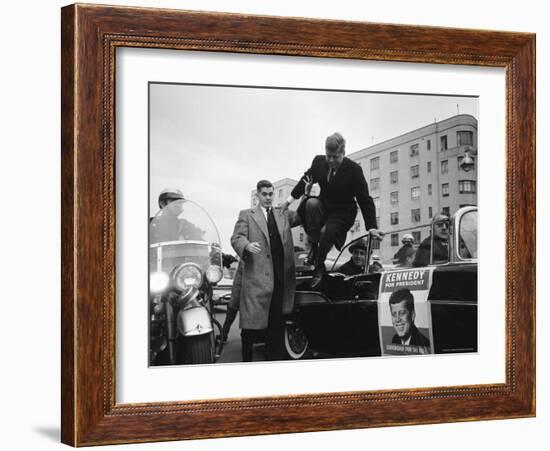 Presidential Candidate John F. Kennedy Leaping from His Car While Campaigning-Paul Schutzer-Framed Photographic Print