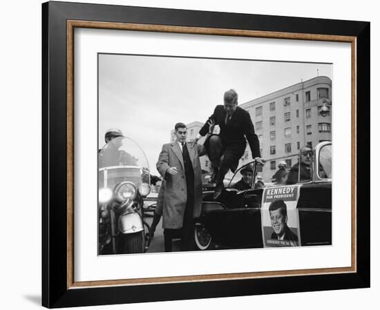 Presidential Candidate John F. Kennedy Leaping from His Car While Campaigning-Paul Schutzer-Framed Photographic Print