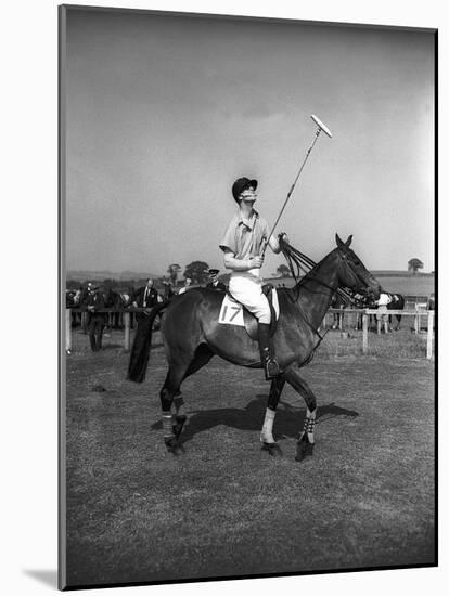 Prince Philips Rides Along on Horseback Holding Polo Stick During Game-null-Mounted Photographic Print
