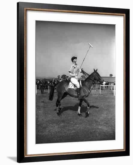 Prince Philips Rides Along on Horseback Holding Polo Stick During Game-null-Framed Photographic Print