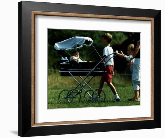 Princess Beatrice is being pushed in pram by Prince william and Harry-null-Framed Photographic Print