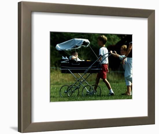 Princess Beatrice is being pushed in pram by Prince william and Harry-null-Framed Photographic Print