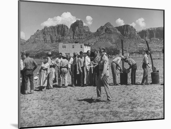 Prisoner Polygamists Lining Up after Chow Beneath the Jagged Arizona Cliffs-Loomis Dean-Mounted Photographic Print