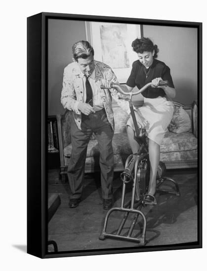 Producer-Director Preston Sturges and His Secretary Trying Out an Exercise Bicycle-John Florea-Framed Premier Image Canvas