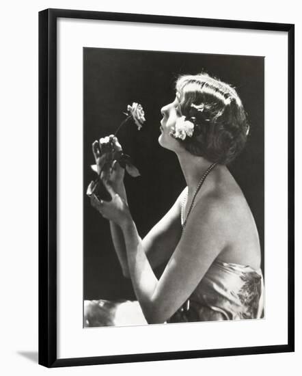 Profile View of Young Woman Smelling Flower-null-Framed Photo