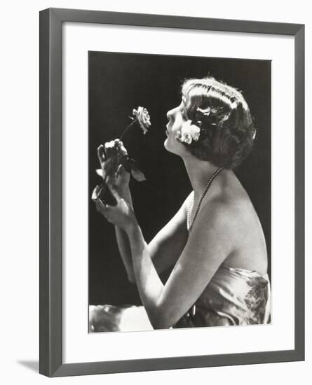 Profile View of Young Woman Smelling Flower-null-Framed Photo