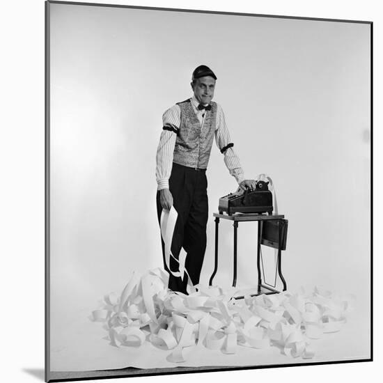 Promotional Shot for the Bob Newhart Show with Bob as Addled Accountant at an Adding Machine-Allan Grant-Mounted Premium Photographic Print
