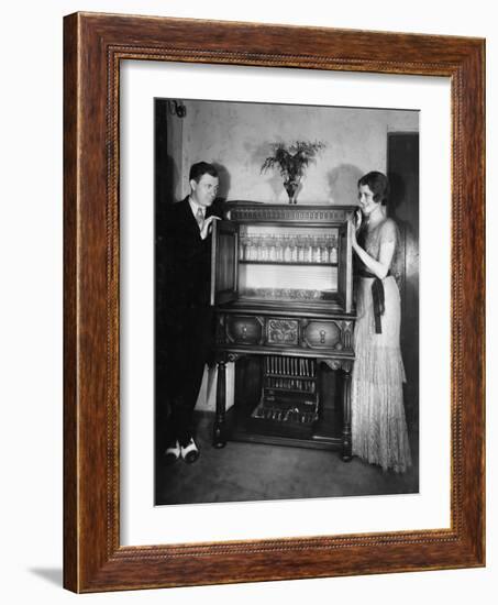 Proud Couple with China Cabinet-null-Framed Photo