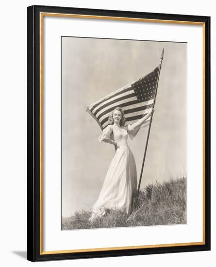 Proud Woman in Gown Holding American Flag on Hill-null-Framed Photo