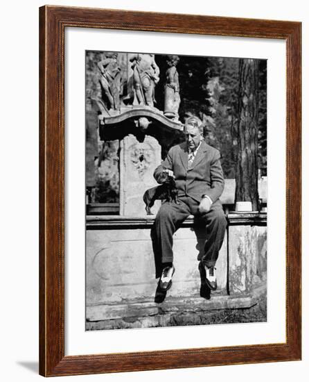 Publisher William Randolph Hearst Sr, Petting Dachshund Gandhi While Sitting on Edge of Fountain-Peter Stackpole-Framed Premium Photographic Print