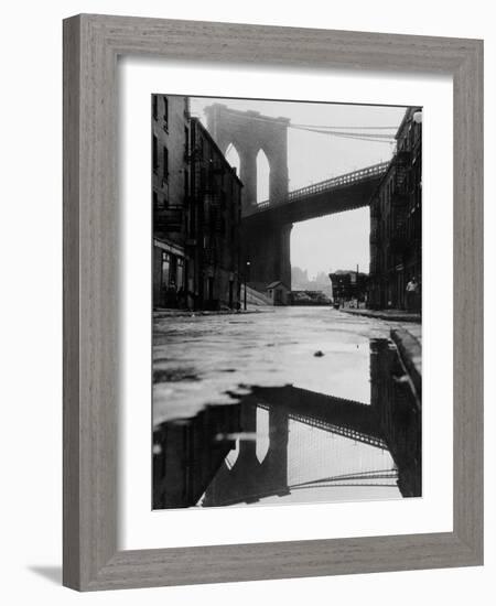 Puddle Reflecting Brooklyn Bridge-Bettmann-Framed Photographic Print