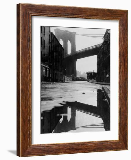 Puddle Reflecting Brooklyn Bridge-Bettmann-Framed Photographic Print