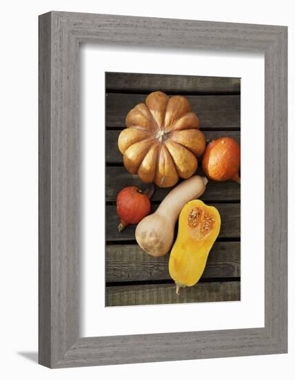 Pumpkin, Butternut- and Hokkaido Squashes on Wooden Background-Fotos mit Geschmack-Framed Photographic Print