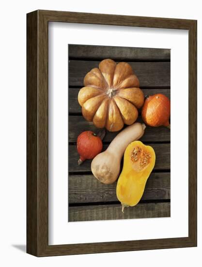 Pumpkin, Butternut- and Hokkaido Squashes on Wooden Background-Fotos mit Geschmack-Framed Photographic Print