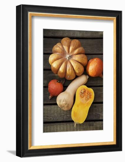 Pumpkin, Butternut- and Hokkaido Squashes on Wooden Background-Fotos mit Geschmack-Framed Photographic Print