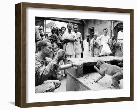 Puppeteer Bil Baird playing with a monkey, March 1962.-James Burke-Framed Premium Photographic Print