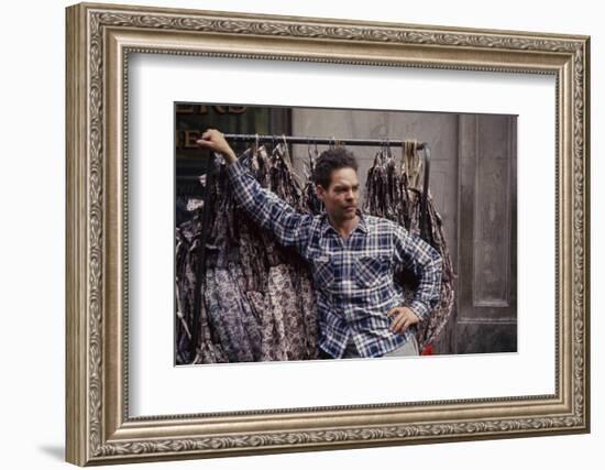 Push Boy as He Leans Against a Racks of Dresses in the Garment District, New York, New York, 1960-Walter Sanders-Framed Photographic Print