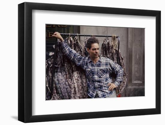 Push Boy as He Leans Against a Racks of Dresses in the Garment District, New York, New York, 1960-Walter Sanders-Framed Photographic Print