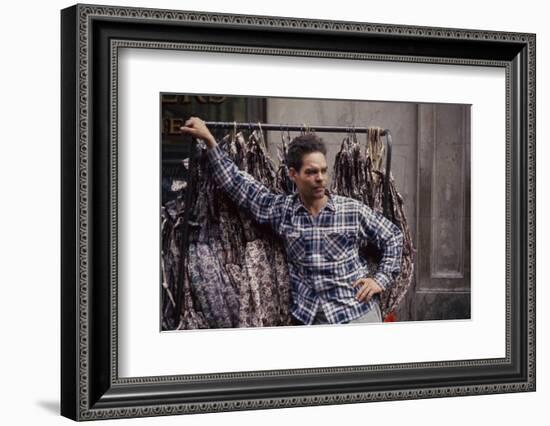 Push Boy as He Leans Against a Racks of Dresses in the Garment District, New York, New York, 1960-Walter Sanders-Framed Photographic Print