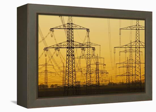 Pylons and power lines in morning light, Germany, Europe-Hans-Peter Merten-Framed Premier Image Canvas