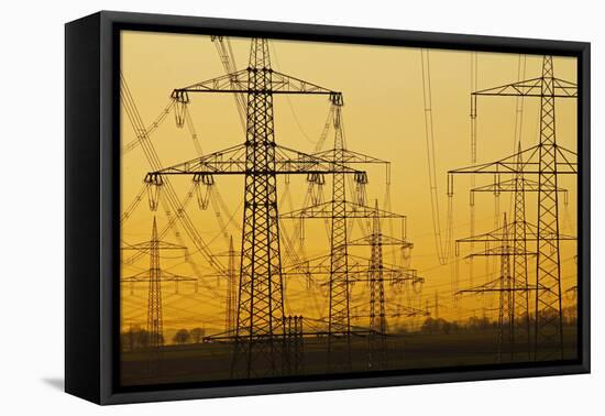 Pylons and power lines in morning light, Germany, Europe-Hans-Peter Merten-Framed Premier Image Canvas