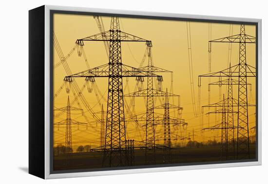 Pylons and power lines in morning light, Germany, Europe-Hans-Peter Merten-Framed Premier Image Canvas