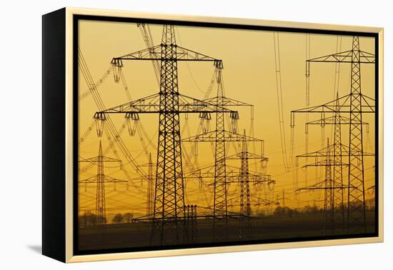 Pylons and power lines in morning light, Germany, Europe-Hans-Peter Merten-Framed Premier Image Canvas